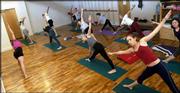 Yoga students emulate poses from instructor Margaret Carr, left,
co-director at Yoga Center of Lawrence, 920 Mass.