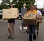 President George Bush Jr., in poster form, accompanies KU students
moving into Oliver Hall. KU opened all residence halls for
occupancy Sunday in Lawrence.