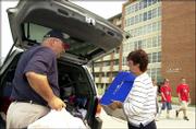 Chuck Pryor and his wife, Marianne Pryor, Washington, Pa., help
carry some of their daughter's belonging to the sixth floor of
Lewis Residence Hall. The Pryors drove 12 hours this weekend to get
their daughter, Chelsey Pryor, to Kansas University for her
freshman year.