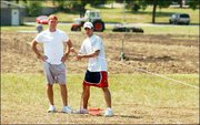 Kansas University program assistants for intramural sports, from
left, Kelly Hill, 22, and Derek Gates, 21, work on setting
boundaries for some playing fields north of the Shenk Recreational
Sports Complex. Shenk fields are being renovated and won't be ready
for the start of fall sports.