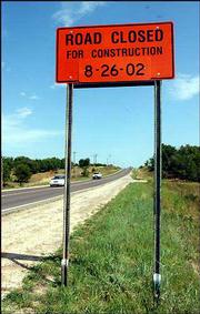 A road sign warns drivers of the closing of a stretch of Stull Road
for an upcoming construction project. The $1.4 million upgrade will
force a detour on the popular Topeka-to-Lawrence road until its
completion next spring.