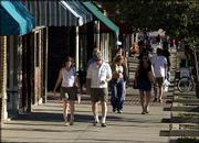 A new Wal-Mart SuperCenter at Sixth Street and Wakarusa Drive may
not steal downtown Lawrence shoppers, like those above, but it may
affect commercial developments in other parts of the city.
