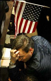 A trader pauses on the floor of the New York Stock Exchange as the
closing bell nears. The Dow Jones closed down 355 points on
Tuesday.
