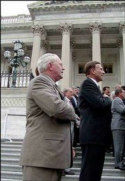 Rep. Joseph Pitts, R-Pa., left, organized House members who said
the Pledge of Allegiance on the steps of the Capitol. A federal
appeals court decision declared the patriotic pledge
unconstitutional because of the words "under God."