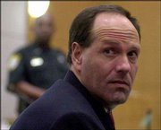Ricky Chavis looks back to see who is in the courtroom just before
the verdict is read in his trial for the murder of family friend
Terry King. Chavis' trial ended a week ago, but the verdict was
sealed until a trial for King's sons, Alex, 13, and Derek, 14, was
finished Friday. The boys were convicted of murdering their father;
Chavis was acquitted.