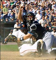 San Francisco's Barry Bonds collides with Arizona catcher Damian
Miller as Bonds scores in the eighth inning. Bonds scored on a
sacrifice fly in the Giants' 3-1 victory Sunday in San Francisco.