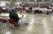 More than 700 people wait for the beginning of the U.S. Army Corps
of Engineers' public hearing on the South Lawrence Trafficway. Army
Col. Dan Curtis, foreground, was in charge of the meeting at the
Douglas County 4-H Fairgrounds.