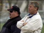 KU football coach Mark Mangino, left, and LHS football coach Dirk Wedd watch an LHS baseball game in this file photo. Lawrence High officials say they have taken "appropriate action" against Mangino after he was involved in an incident after Friday&squot;s LHS-Olathe East football game.
