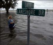 Virginia Williams watches Lake Pontchartrain rise as Tropical Storm
Isidore blows ashore in Mandeville, La. Isidore dropped 15 inches
of rain on the Gulf Coast Thursday and caused at least $18 million
in damage in Louisiana. The storm is expected to move into the Ohio
Valley this weekend, bringing heavy rain to the Midwest and
Northeast.