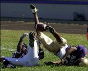 Haskell defensive back Martin Woods, right, breaks up a pass
intended for Langston receiver Terry Moss.