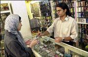 A young Iranian woman purchases a music cassette in Tehran. An $8
million, U.S.-funded radio station is preparing to reach out to
young Iranians. The broadcasts, scheduled to begin early next year,
are another attempt by Washington to use youth-oriented media to
bolster America's sagging image in the Islamic world.