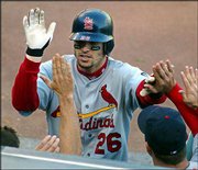 St. Louis' Eli Marrero accepts congratulations after swatting a
tie-breaking home run. The Cardinals defeated the Giants, 5-4,
Saturday in San Francisco, but the Giants still lead the NL
championship series, two games to one.