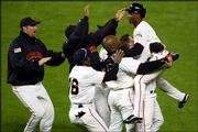 San Francisco players lift Kenny Lofton, right, into the air after
the veteran outfielder drove in the winning run with a hit in the
bottom of the ninth inning. The Giants defeated St. Louis, 2-1,
Monday night in Game 5 of the NLCS to win their first pennant since
1989. The Giants will face the Angels in the World Series, which
begins Saturday at Anaheim, Calif.