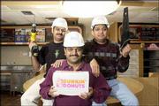 Dunkin Donuts, 521 W. 23rd St., is closed for a rebuilding project.
The owners, from left, Lala Patel, Sonny Patel and Dee Patel, are
pictured in the building Wednesday. The building will be torn down
during the next week. A new building is scheduled to be built with
a drive-through window and outdoor patio.