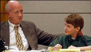 Attorney James Stokes, left, gets a smile from Alex King as Judge
Frank Bell overturns the convictions of Alex and his brother Derek.
On Thursday the judge also ordered a new trial for the boys, who
are accused of killing their father, Terry King.