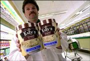 Steve Luongo, dairy manager of Super Fresh supermarket in
Northfield, N.J., holds the original half-gallon size ice cream
container, at left, and the new 1.75-quart container. Edy's is
among the brands changing to a smaller size container to
effectively deal with increasing costs without increasing the price
of their product.