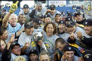 Los Angeles captain Cobi Jones, holding MLS Cup, celebrates with
Carlos Ruiz, left of trophy, who scored the game-winning goal. The
Galaxy defeated New England, 1-0, in overtime Sunday at Gilette
Stadium in Foxboro, Mass.