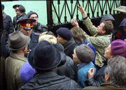 A police officer, left, speaks with relatives of freed hostages
attempting to enter the City Clinical Hospital No.13, where dozens
of ex-hostages were treated after the Moscow theater hostage
crisis. Hundreds of freed captives were taken to area hospitals,
most of them suffering from sleeping gas that had been sprayed
through the building before the raid.