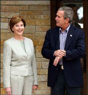 President Bush and first lady Laura Bush are shown at their ranch
in Crawford, Tex. The Bushes were waiting last week for a visit by
Chinese President Jiang Zemin. The president at times gets himself
in hot water with both his critics and his wife for his terms of
endearment.
