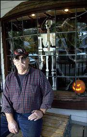 The highlight of Ed Boyle's house at 310 Elm St. is his spooky
front window complete with a hanging skeleton.