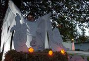 Jared Klug, 12, wears a costume to complement the ghostly decor
outside his house at 3425 W. 10th Place. The Klug family
decorations also feature a oak tree decorated with lights and a fog
machine.