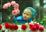 A girl places flowers Sunday outside a theater in downtown Moscow.
On Saturday, Russian special forces ended a hostage crisis at the
theater with gunfire and sleeping gas that killed at least 116
people.