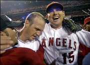Anaheim closer Troy Percival, center, and Tim Salmon celebrate with
teammates. The Angels won Game 7 of the World Series, 4-1, against
San Francisco to win the championship Sunday in Anaheim, Calif.