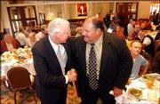 Kansas State coach Bill Snyder, left, greets Kansas coach Mark
Mangino during the Greater Kansas City Sports Commission luncheon
last August. Mangino will meet his former boss again Saturday when
KU plays host to K-State.