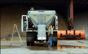 John Barnes, a city maintenance worker, lubricates the gears on a
sand truck in front of storage bins holding salt and sand. Tuesday,
workers gave snow-clearing equipment a trial run in preparation for
winter weather. Ross Janssen, 6News meteorologist, said a mix of
snow and rain was possible this afternoon.