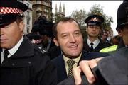 A Former butler to Princess Diana, Paul Burrell makes his way
through the crowd after being released from the Old Bailey court in
London, after the case against him collapsed and he was found
innocent on all counts of theft. The trial came to a premature end
after it emerged Friday that Burrell had told Queen Elizabeth II
that he had been keeping items belonging to Diana for safekeeping.