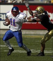 Kansas University running back Reggie Duncan, left, brushes off
Colorado linebacker Joey Johnson in this 2001 file photo.