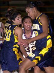 Haskell's Shawnavyn Joe, center, is trapped between Graceland
defenders. The Fightin' Indians won Saturday at Haskell.