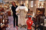 Sharon Dowdle, event manager at Butterfields auction house in San
Francisco, displays a gown and personal effects owned by Esther
Lederer, better known as Ann Landers. Property from the late advice
columnist fetched nearly $250,000 Monday.