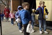Preschoolers from the Lawrence Arts Center, 940 N.H., deliver gift
bags at the Salvation Army, 946 N.H., one of the 29 agencies that
receive funding from the United Way of Douglas County. The bags of
soaps and shaving cream and other personal items, delivered Monday,
will be distributed by the Salvation Army at its shelter Christmas
party in December. From left are Kenny Brumley, preschool director
Linda Reimond, Will Richardson, Josie Hilton, Sean Jesse, Jedzia
Hicklin, Charlie Carr and Brio Ratzlaff.