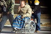 Robert Marx, a local homeless man, gets a push by a friend as they
head to LINK for lunch Thursday afternoon. Shelters and other
agencies are reporting more people using their services even as
state funding dwindles.