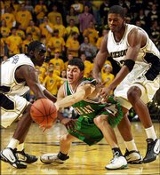 UW-Green Bay's Greg Monfre, center, pushes the ball away from
Missouri's Jimmy McKinney, left, and Jefferey Ferguson during
Monday's game in Columbia, Mo.