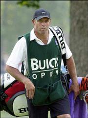 Steve Williams, caddie for Tiger Woods, has a bead on some rowdy
fans during the Buick Open last August. Not long after someone took
a picture of Woods during his swing at the Skins Game, Williams
tossed the camera into a pond.