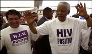 Former South African President Nelson Mandela, right, and AIDS
activist Zackie Achmat visit the Nolungile Clinic and Community
Health Center in Khayelitsha, Cape Town, South Africa. Mandela has
emerged as a champion of the fight against the country's rampant
AIDS epidemic.