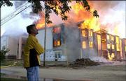 Doug Compton, owner of First Management Inc. watched the May 18
fire that destroyed a nearly finished 21 unit building at Chase
Court Apartments, 1942 Stewart Ave. Two occupied apartment
buildings were damaged in the blaze. A thick column of black smoke
and flames could be seen for miles. No one was injured.