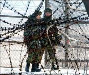 South Korean soldiers walk between fence and barbed wire as they
patrol against the Imjingak Pavillion near the border village of
the Panmunjom, South Korea. North Korea may be trying to pit South
Korea against the United States.