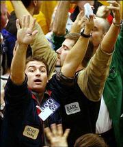 Traders Vincent D'Agostino, foreground, and Earl Counter signal
orders near the close of trading in the Standard & Poor's 500
Futures pit at the Chicago Mercantile Exchange. Anticipation of a
tax cut when President Bush announces his economic stimulus package
today sent stocks higher. The Dow Jones industrials closed up more
than 170 points Monday.