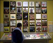 A museum patron looks at a collection of Beatles album covers on
display with an exhibit titled "The Beatles: Now and Then," a
collection of photographs by photojournalist Harry Benson, at the
Albany Institute of History and Art in Albany, N.Y. Dutch police
claim to have recovered hundreds of original Beatles tapes that
were stolen in the 1970s.