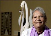 Doris Pilkington, author of "Follow the Rabbit-Proof Fence," poses
for a portrait in front of contemporary aboriginal art from
Ramingining, Australia, at the Asia Society in New York City.
Pilkington, 65, is herself an Australian Aborigine.