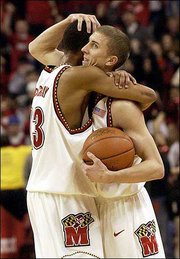 Maryland's Steve Blake, right, and teammate Chris McCray celebrate
an 87-72 victory over Duke. The No. 17 Terrapins stunned the
top-ranked Blue Devils on Saturday in College Park, Md.