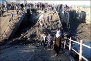 Palestinians surround the remains of a destroyed bridge in Beit
Hanoun in the Northern Gaza strip. Israeli forces early Saturday
used dynamite to destroy the bridge, which they said was used by
militants to fire rockets at Israeli towns.