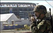 CPl. Bill Doke of the California National Guard patrols outside
Qualcomm Stadium. Security is expected to be tight for Super Bowl
XXXVII today at San Diego.