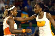 Serena Williams, left, accepts congratulations from her sister,
Venus, after winning the Australian Open.