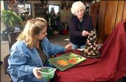 baldwin residents Christy Carlisle and Sandy Cardens put finishing
touches on their creations for the 15th annual Chocolate Auction.
Bidding starts at 2 p.m. Feb. 9 at Baldwin High School, 415
Eisenhower St. Proceeds will fund arts opportunities for children
and adults in Baldwin.
