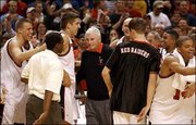 Texas Tech players congratulate coach Bob Knight, center, after
Knight became the fourth NCAA Division One men's coach to record
800 victories. Knight hit the milestone with a 75-49 victory
Wednesday over Nebraska in Lubbock, Texas.