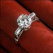 This Tiffany-style setting with a solitary brilliant-cut diamond
suspended above two baguette diamond shoulders is from the 19th
century. It is part of Diamonds & the Power of Love, an exhibit
sponsored by the Diamond Information Center.